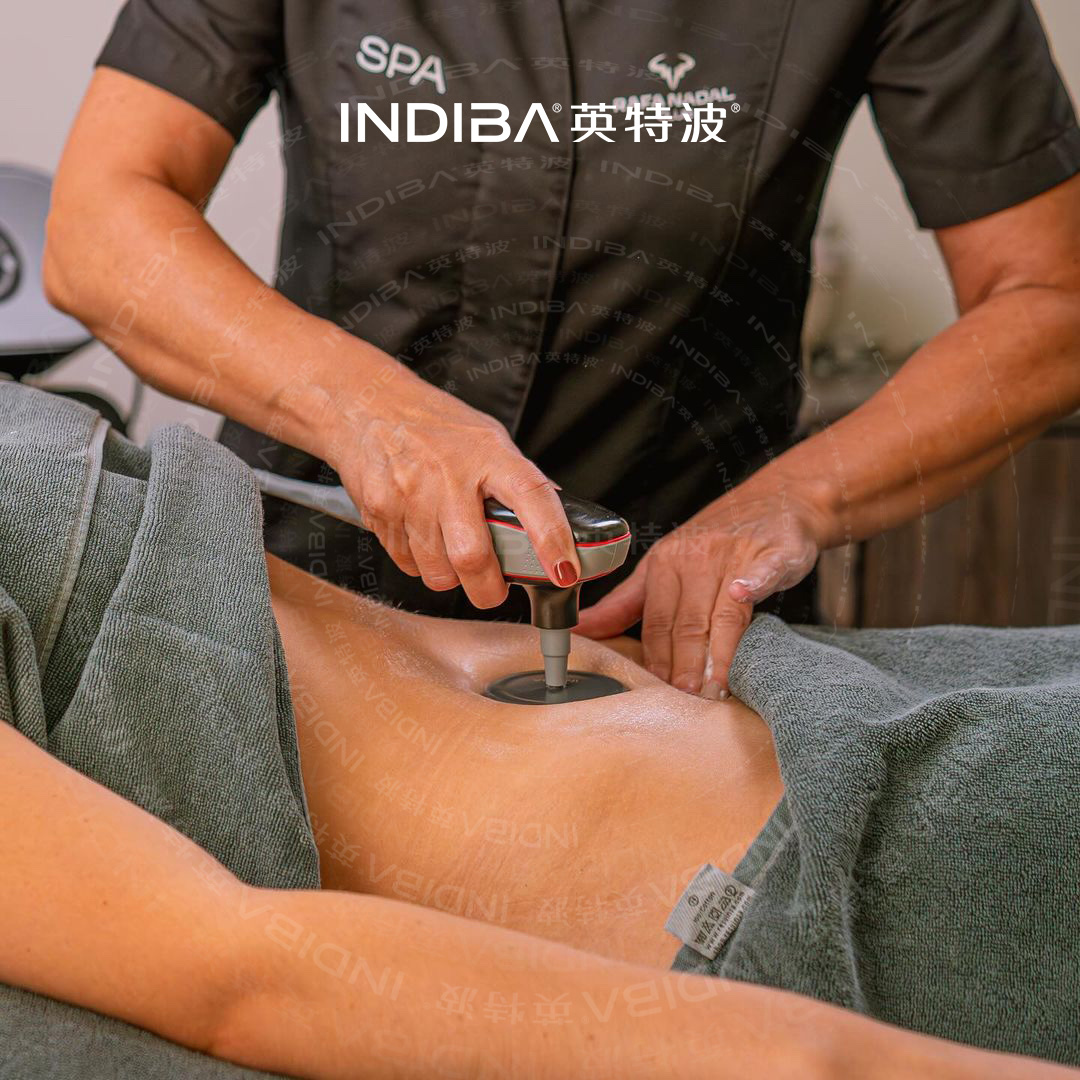 Therapist applying an authentic INDIBA electrode during treatment